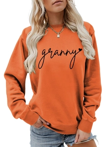 Detailed view of the orange crewneck sweatshirt with black granny heart print texture