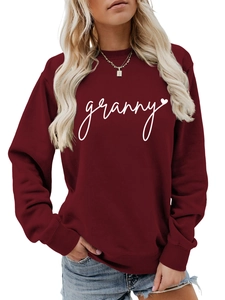 Macro detail of ribbed cuffs and granny heart print on burgundy crewneck sweatshirt