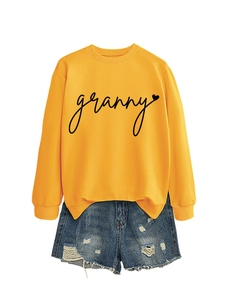 Detail of yellow round neck sweatshirt with granny print and distressed denim shorts