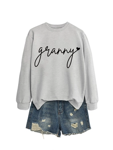 Flat lay of gray sweatshirt with granny heart print and ripped denim shorts