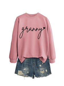 Detail of pink crewneck sweatshirt with 'granny' heart print and distressed denim shorts