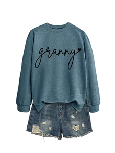 Detail of teal crewneck sweatshirt with black granny heart print and denim shorts