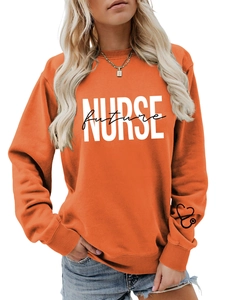Close-up of orange sweatshirt showing heart stethoscope logo and NURSE future print