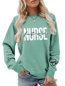 Detail of mint green sweatshirt featuring Nurse Future print and stethoscope on cuff