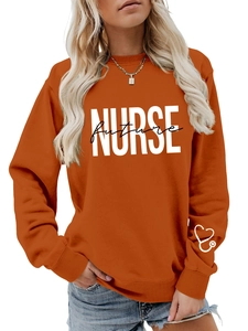 Detail of orange nurse future sweatshirt with white heart stethoscope on the sleeve