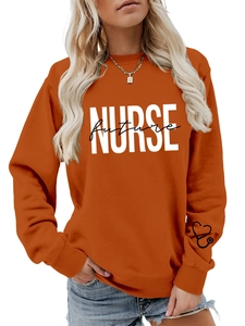 Close-up of Future Nurse lettering and heart stethoscope detail on orange sweatshirt