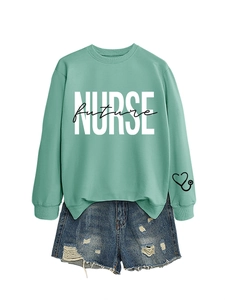 Detail of mint green Nurse Future sweatshirt with white bold text and blue denim shorts