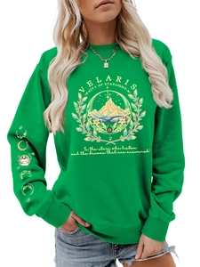 Close-up of Velaris mountain logo and moon phase embroidery on green cotton sweatshirt