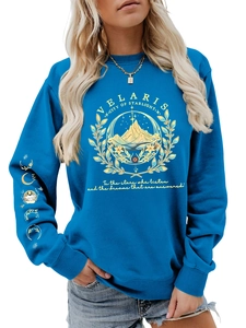 Detail of royal blue Velaris sweatshirt featuring golden mountain print and moon phase sleeves
