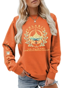 Detail of Velaris orange sweatshirt with mountain print and moon phase cuff embroidery