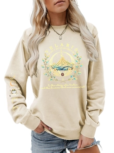 Detail of Velaris print sweatshirt showing artistic moon phase graphics on the sleeve cuff