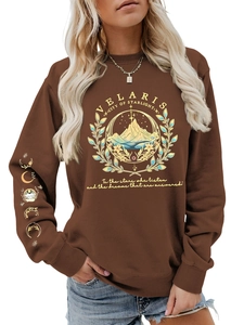 Detail of Velaris City of Starlight print and moon phase symbols on brown sweatshirt sleeve