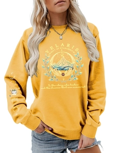 Detail of yellow Velaris sweatshirt featuring celestial mountain art and moon phase sleeve print