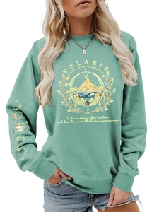 Detail of mint green Velaris sweatshirt featuring mountain print and moon phase on sleeve