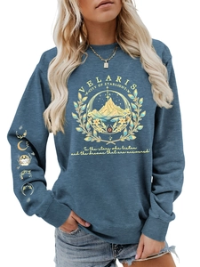 Detailed close-up of Velaris sweatshirt moon phases print on sleeve and golden mountain art