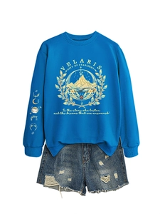 Detail of royal blue Velaris sweatshirt with gold graphic print and moon phase sleeve design