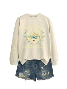 Flat lay of cream Velaris sweatshirt with mountain print and distressed denim shorts