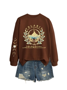 Close-up of golden Velaris screen print and moon phase symbols on a brown sweatshirt