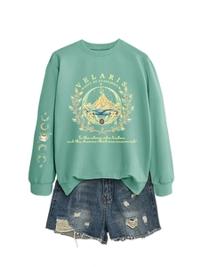Detailed view of mint green Velaris sweatshirt featuring gold logo and starlinght embroidery