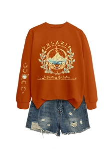 Flat lay of Velaris starlight hoodie with moon phase sleeve and ripped denim shorts