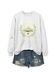 Detail of Velaris City of Starlight light gray sweatshirt and blue distressed denim shorts