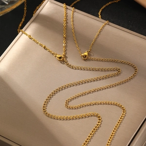 Double-layered gold snake chain body jewelry with lobster clasp on a metallic display box