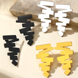 Three pairs of geometric stainless steel stud earrings in black, white, and gold finish