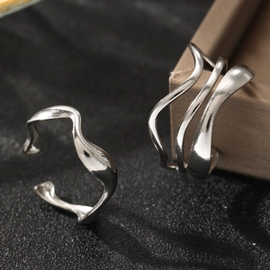 Modern geometric oval stainless steel rings with a wavy abstract design in silver finish