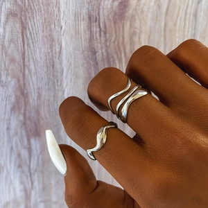 Minimalist geometric wave rings set in stainless steel for a trendy stacked fashion look