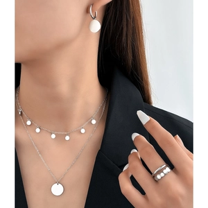 Minimalist silver multilayer necklace set with disc pendants on high quality polished metal