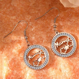 Silver hollow round Mama earrings with white rhinestones on orange textured background