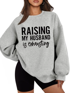 Close-up of light grey crewneck sweatshirt with Raising My Husband text and dropped shoulders