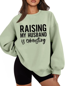 Detail of sage green oversized sweatshirt with Raising My Husband is exhausting print