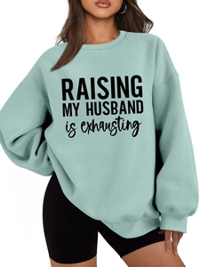 Close-up of ribbed cuffs and thick fabric on light blue Raising My Husband sweatshirt
