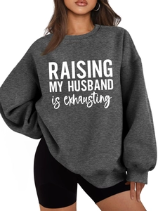 Detail of dark gray sweatshirt with Raising My Husband is exhausting white slogan