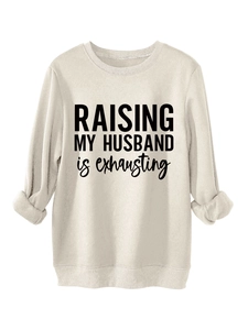 Detail of soft beige fleece sweatshirt fabric with black slogan print and ribbed cuffs