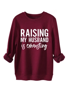 Close-up of the ribbed crewneck and white printed lettering on the burgundy sweatshirt