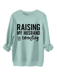 Close-up of mint green crewneck sweatshirt with Raising My Husband lettering