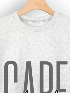 Close-up of ribbed neckline and CADE letter print on gray melange sweatshirt