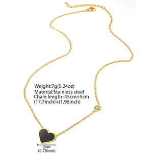 Golden stainless steel heart pendant necklace with zircon detail on white background