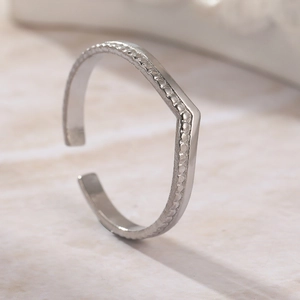 Minimalist double layer V-shaped open ring with silver beaded texture on marble