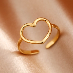 Polished gold heart open ring in minimalist stainless steel on champagne silk