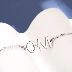 Bracelet personnalisé en acier inoxydable avec lettres C et M et détail en cœur