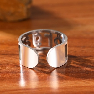 Polished stainless steel adjustable ring featuring hollow numeric 19 design on wood surface