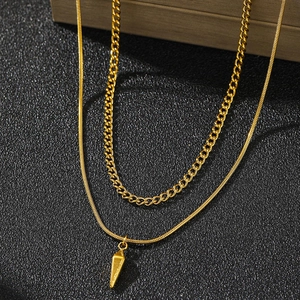 Golden double layered necklace featuring a Cuban chain and snake chain with cone pendant