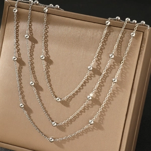 Bohemian multi-layer stainless steel beaded chain necklace on champagne gift box