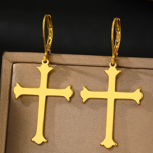 Vintage golden cross earrings with ornate floral edges on silk jewelry display box