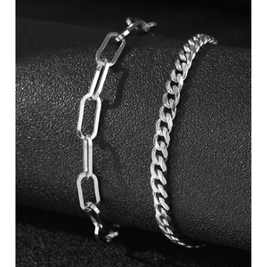 Minimalist silver anklet set featuring paperclip and curb chains on a display