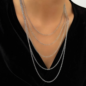 Minimalist multi-layered silver snake chain necklace featuring five rows of sleek metal links