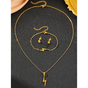 Detail of lightning bolt pendant jewelry set in gold finish with a sleek luxury feel